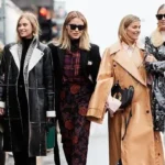 Five stylish women walking on the street, each wearing fashionable winter coats and accessories, showcasing different styles and trends in outerwear.
